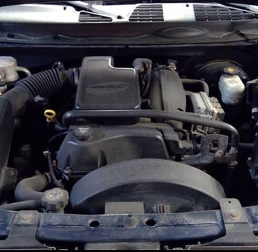A detailed view of a General Motors Vortec 4200 engine inside a car engine bay.
