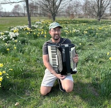 Accordion player in field of flowers