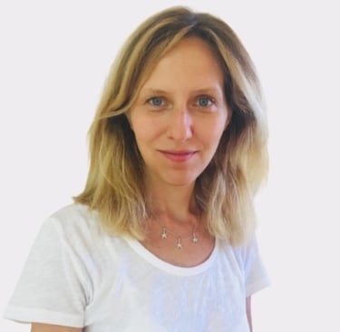 a woman with blonde hair and a white shirt