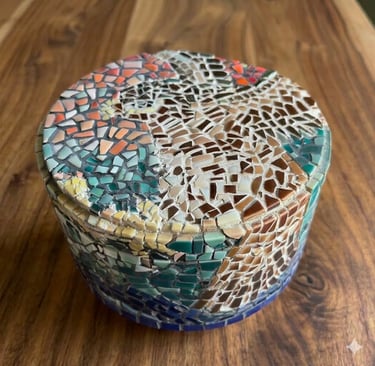 Top down view of "Vessel of Remembrance" mosaic showing airborne falcon & multicolored ceramic tiles