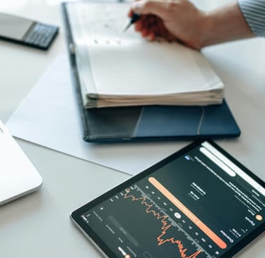 Consultant executing strategy with laptop, tablet, and notes during project planning