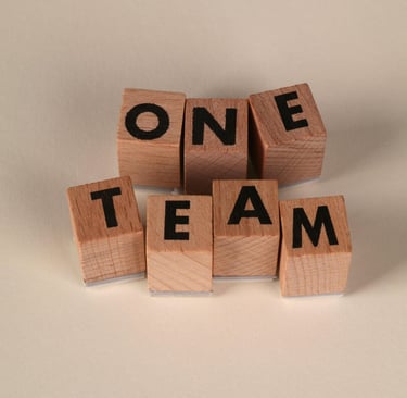 Blocks spelling 'ONE TEAM', symbolizing teamwork, collaboration, and alignment