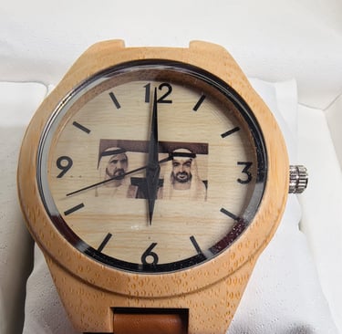 Custom wooden watch with a brown leather strap and engraved portrait of Arab leaders.