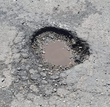 Pothole that needs repaired on parking lot job