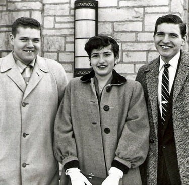 two men and a woman standing next to each other