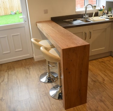 Breakfast bar. L shaped table with mitred joint made from oak veneered ply.