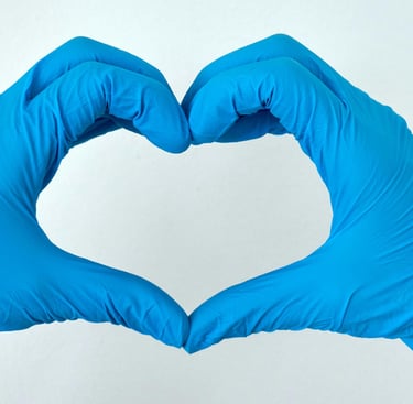 blue-gloved hands making a heart shape