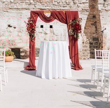 a wedding ceremony with a red drapeed up wedding ceremony