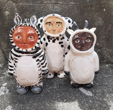 three ceramic animal statues of zebr, dalmation and mountain goat smittie