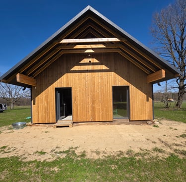 a wooden structure with a shadow of a person standing in front of a tree