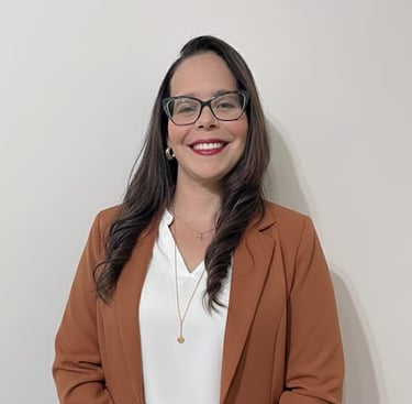 a woman in a brown blazer and glasses