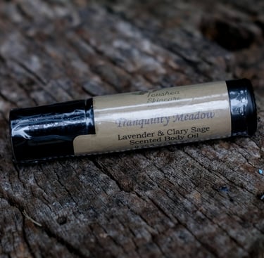 body oil in black vial on a tree stump