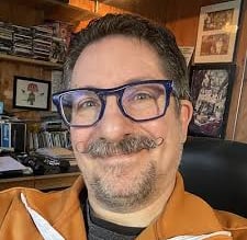 a man with glasses and a beard and mustache