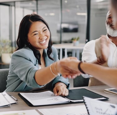 a woman shaking hands with a man in a suit