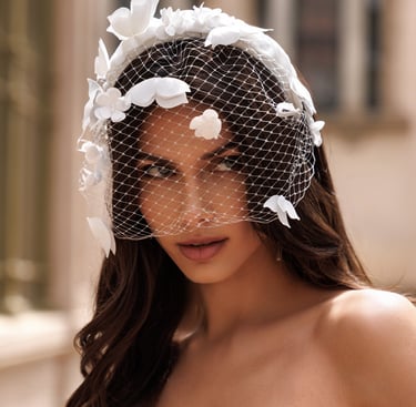 a woman in a wedding dress with a veil and veil