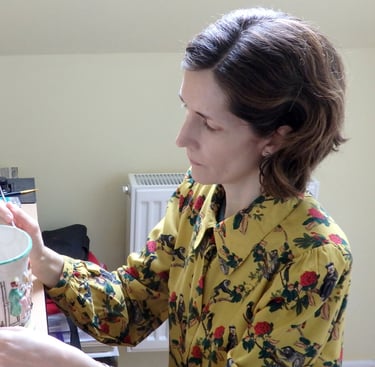 Mandy conserving a ceramic frog surprise mug