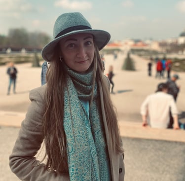 a woman in a hat and scarf on a sunny day