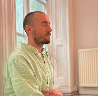 a man sitting with eyes closed meditating