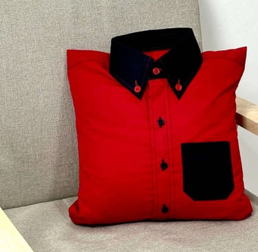 a red shirt pillow sitting on a chair