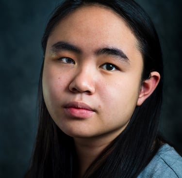 a woman with long hair and a gray shirt