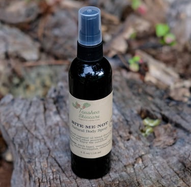 black spray bottle of liquid on a tree stump