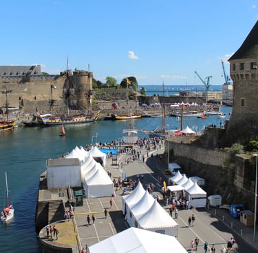 a large group of tents and tents are set up in a harbor