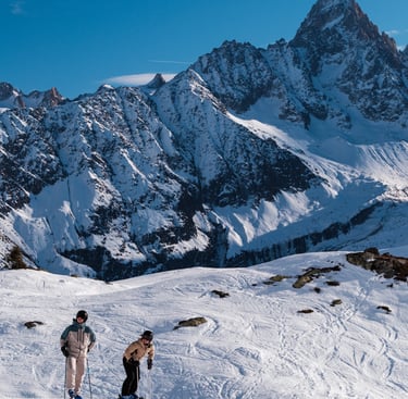 two people skiing down a snowy mountain