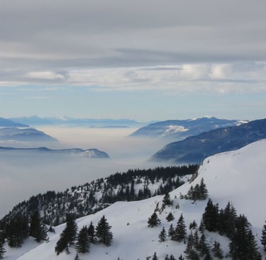 a person on a ski slope with a view of the mountains