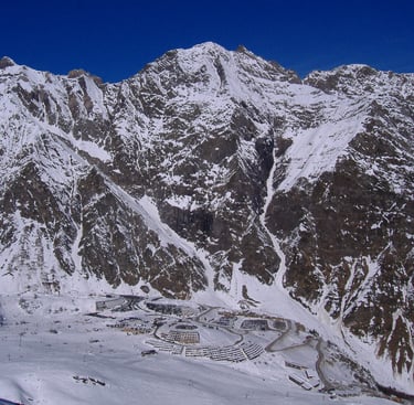 a person on a snowboard in the mountains