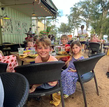 Kids dinning on a beachfront restuarant
