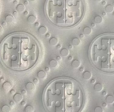 Detailed debossed pattern on material, creating a subtle and tactile finish by King Fly.