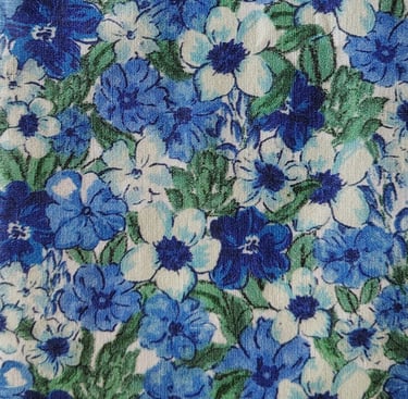 a close up of a blue and white floral print fabric