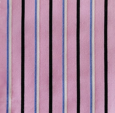 a pink shirt with a black and white striped tie