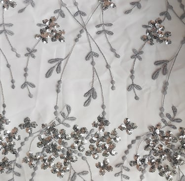 a fabric with silver sequinne and silver beads