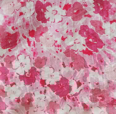 a pink and white floral print fabric with a pink flower