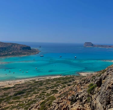 a view of a beach with boats and a blue sky