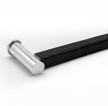 Photography case study featuring a cabinet pull with a leather wrap and silver metal finish.