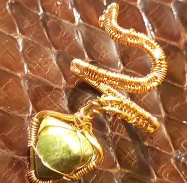 a green stone pendant with a gold chain link
