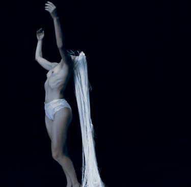 Film still from “Der Schatten” by Tina Bikic showing a dancer in motion, wearing a white mask and costume.
