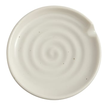 Speckled off-white ceramic spoon rest with spiral design and curved edge