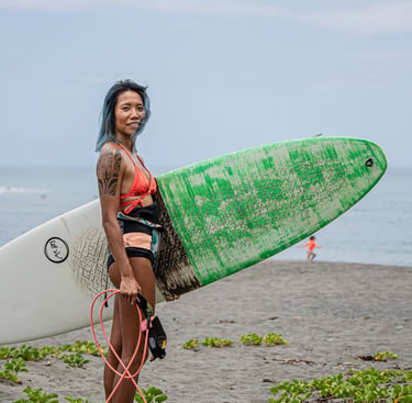 a woman in a bikini top and a surfboard