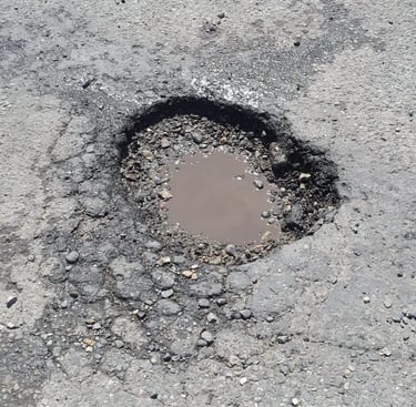 Pothole that needs repaired on parking lot job