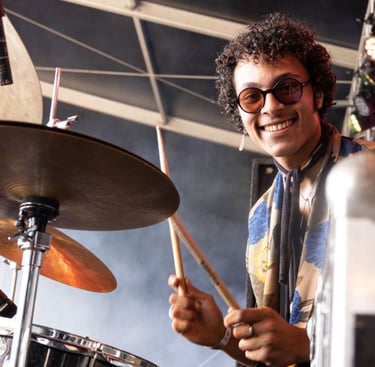 a man with glasses and a scarf on a stage