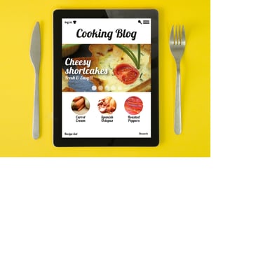Photo of a tablet between a knife and fork. Tablet says "Cooking Blog"