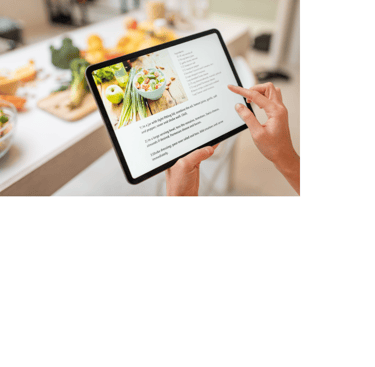 Person using a tablet to display a recipe. Ingredients are blurred out in the background