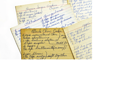 Photo of several yellowed recipe cards with handwritten recipes on them