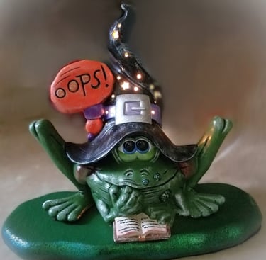 A witch turned into a frog with a lighted hat.