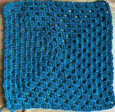 Two granny squares—one twisted, one flat after turning rounds.