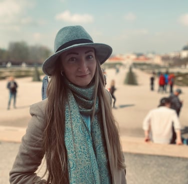 a woman in a hat and scarf on a sunny day