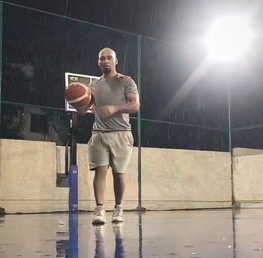 a man holding a basketball ball on a basketball court